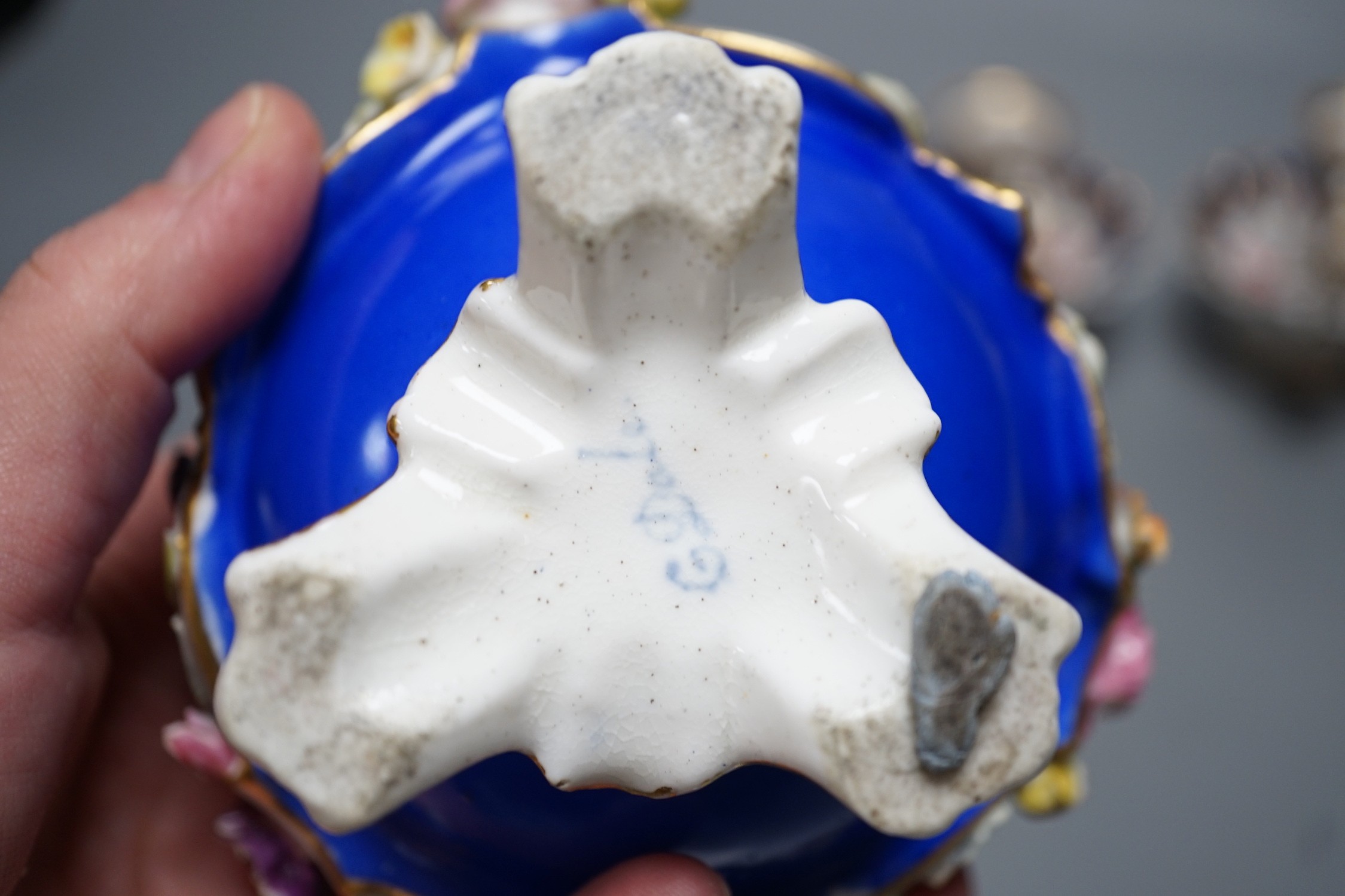 A Coalport floral encrusted inkwell cover and liner, marked C-Dale in blue and two English porcelain tapersticks painted with roses perhaps Coalport, c.1820